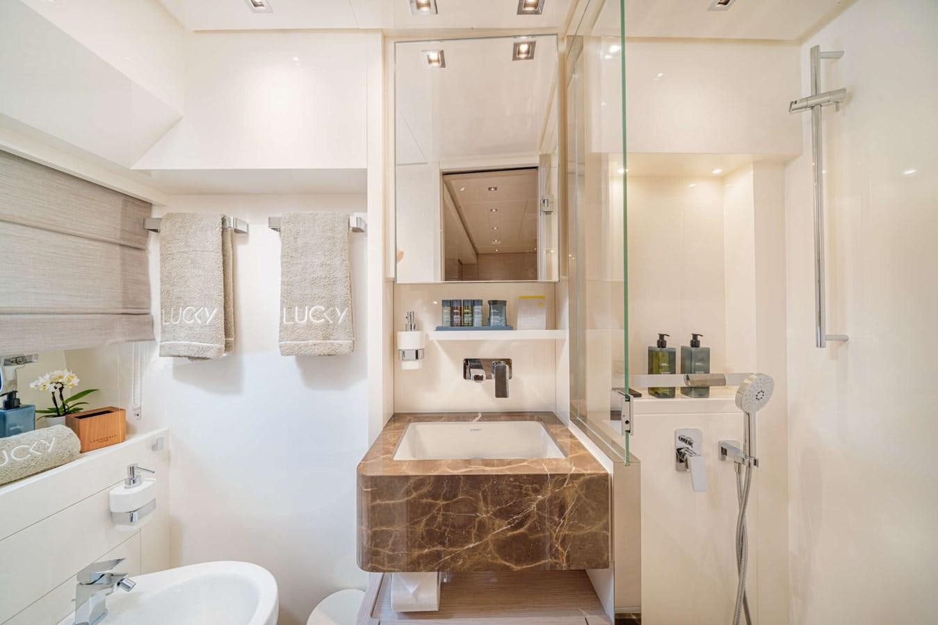 a bathroom with a sink and a mirror aboard LUCKY Yacht for Sale