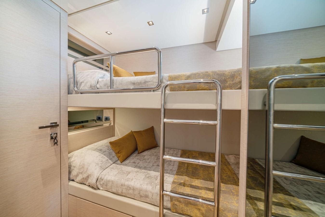 a bed with a ladder aboard LUCKY Yacht for Sale