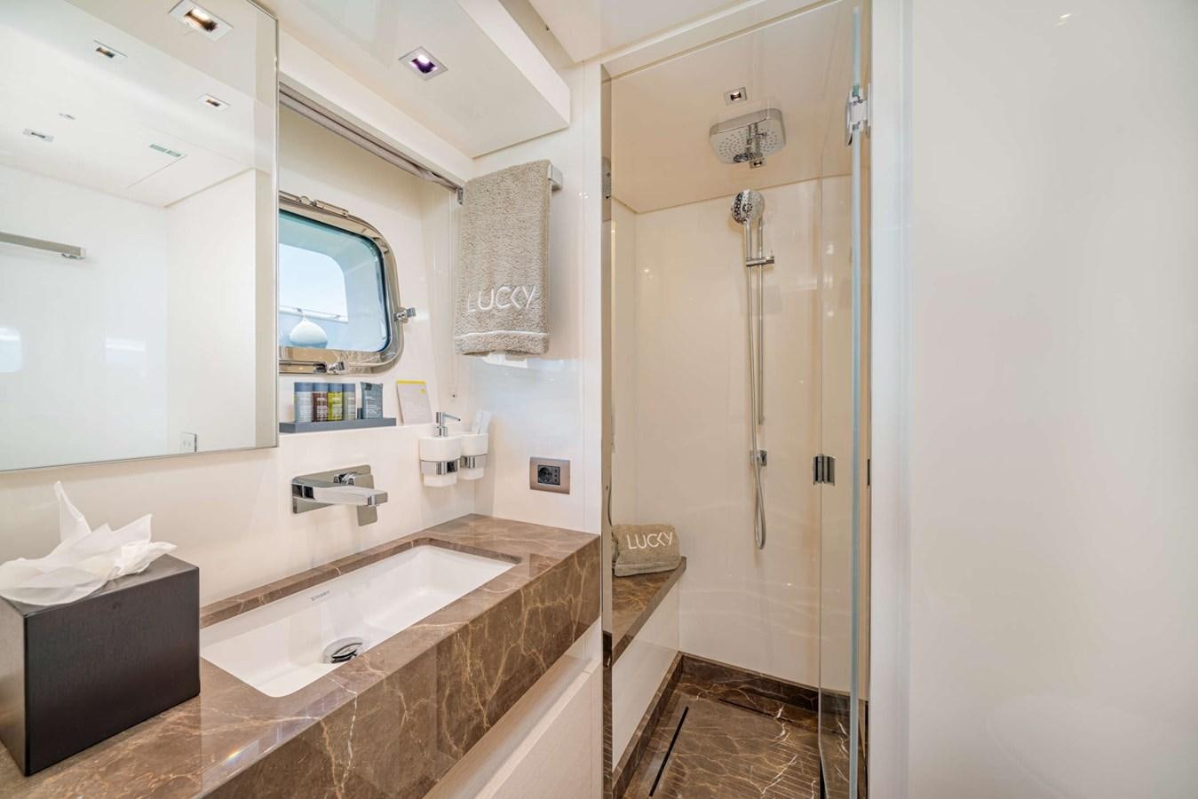 a bathroom with a sink and a shower aboard LUCKY Yacht for Sale