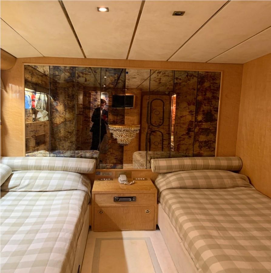 a room with a bed and a painting on the wall aboard BAHIRA II Yacht for Sale