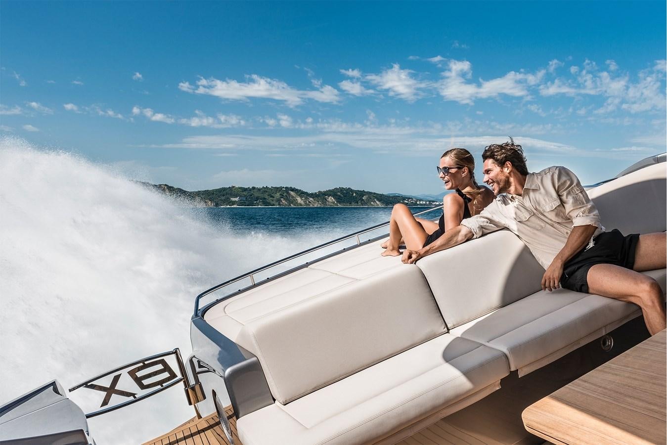 a man and woman sitting on a boat in the water aboard PERSHING 8X   Yacht for Sale
