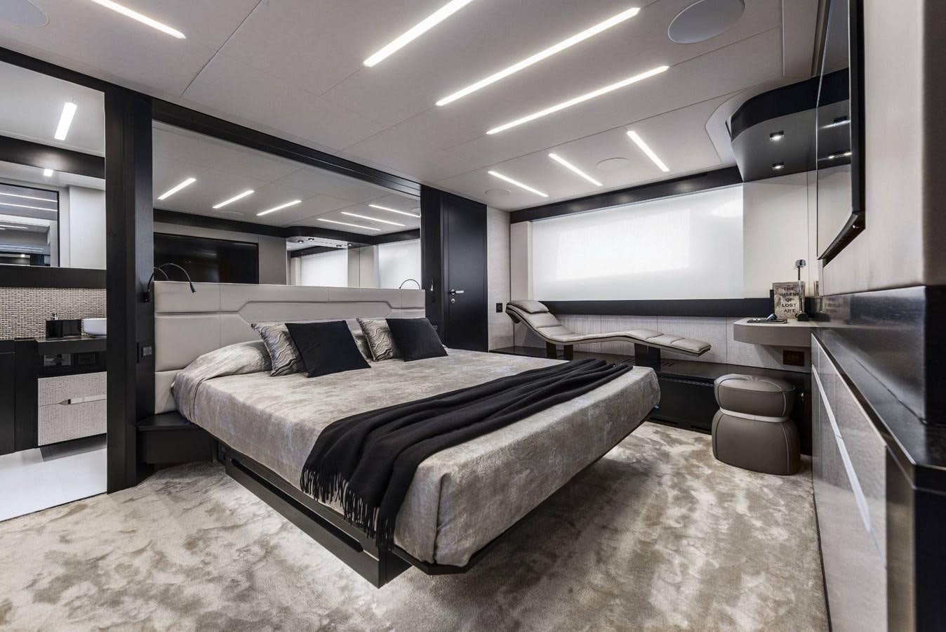 a bedroom with a bed and desk aboard PERSHING 8X   Yacht for Sale