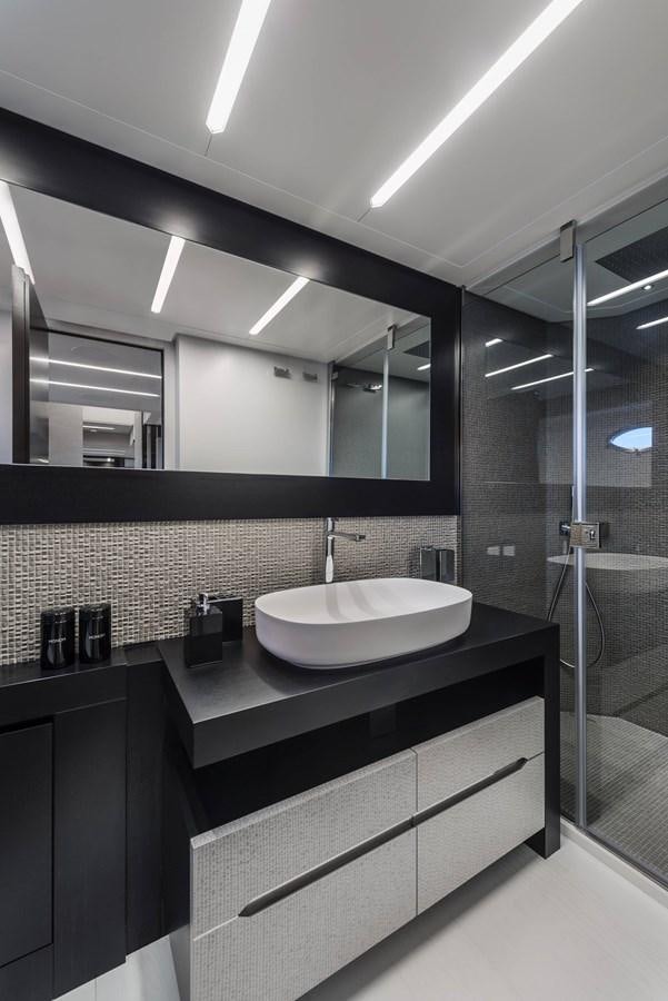 a bathroom with a large mirror aboard PERSHING 8X   Yacht for Sale