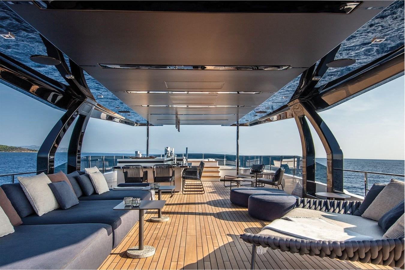 a large lounge area with a large deck and a large body of water aboard CUSTOM LINE NAVETTA 42/10 Yacht for Sale