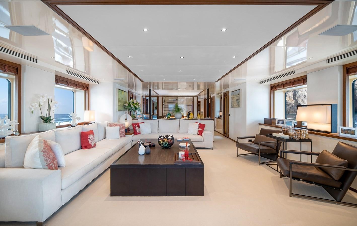 a living room with a couch and a coffee table aboard IRAVATI Yacht for Sale