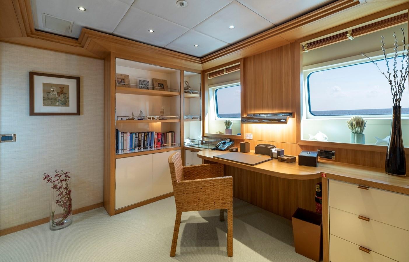a room with a desk and a chair and a window aboard IRAVATI Yacht for Sale