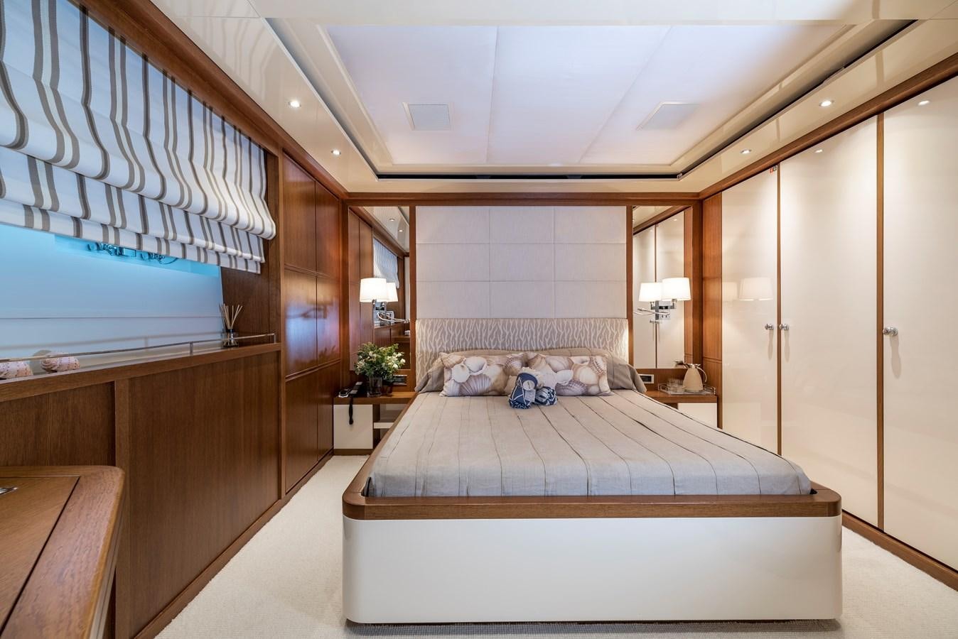 a large bedroom with a large bed aboard IRAVATI Yacht for Sale