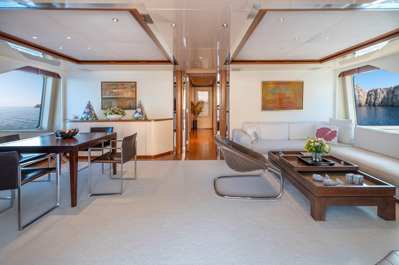 a living room with a large table aboard IRAVATI Yacht for Sale