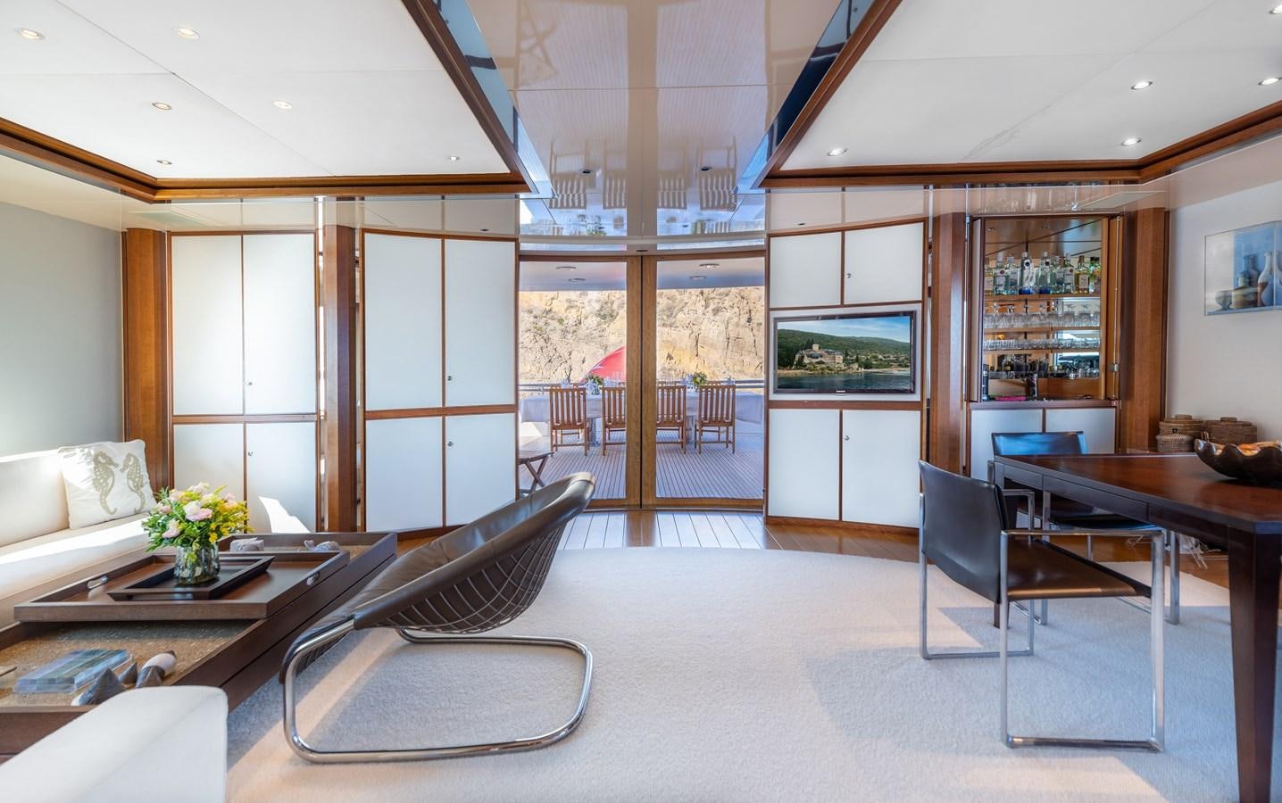 a room with a table chairs and a couch aboard IRAVATI Yacht for Sale