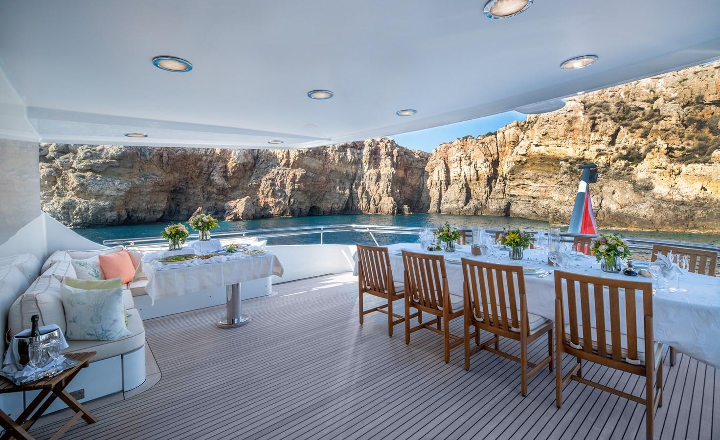 a patio with chairs and tables aboard IRAVATI Yacht for Sale