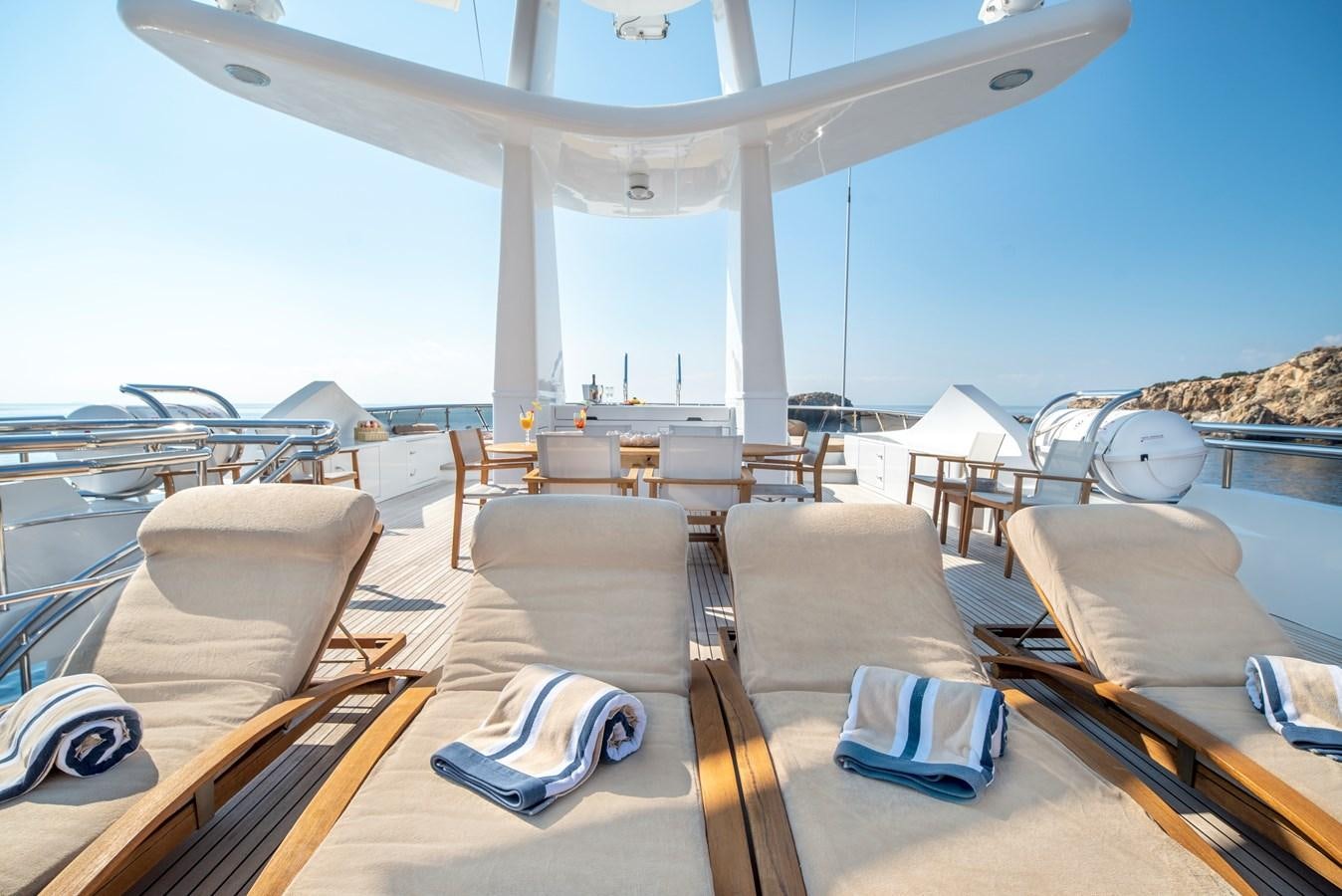 a lounge area with a large white tent and chairs aboard IRAVATI Yacht for Sale