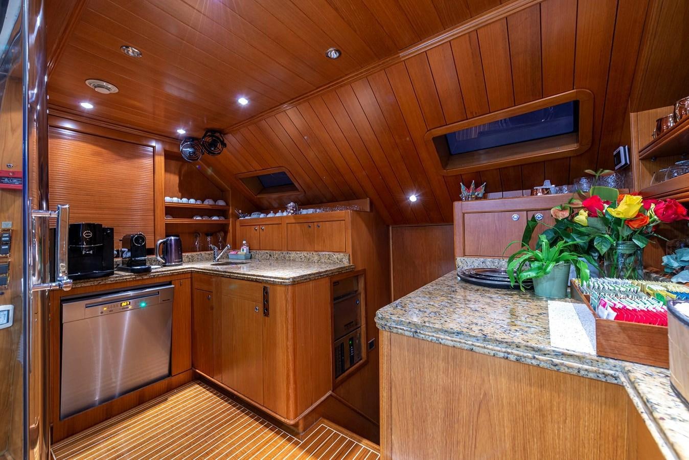 a kitchen with wooden cabinets aboard NEW STAR Yacht for Sale