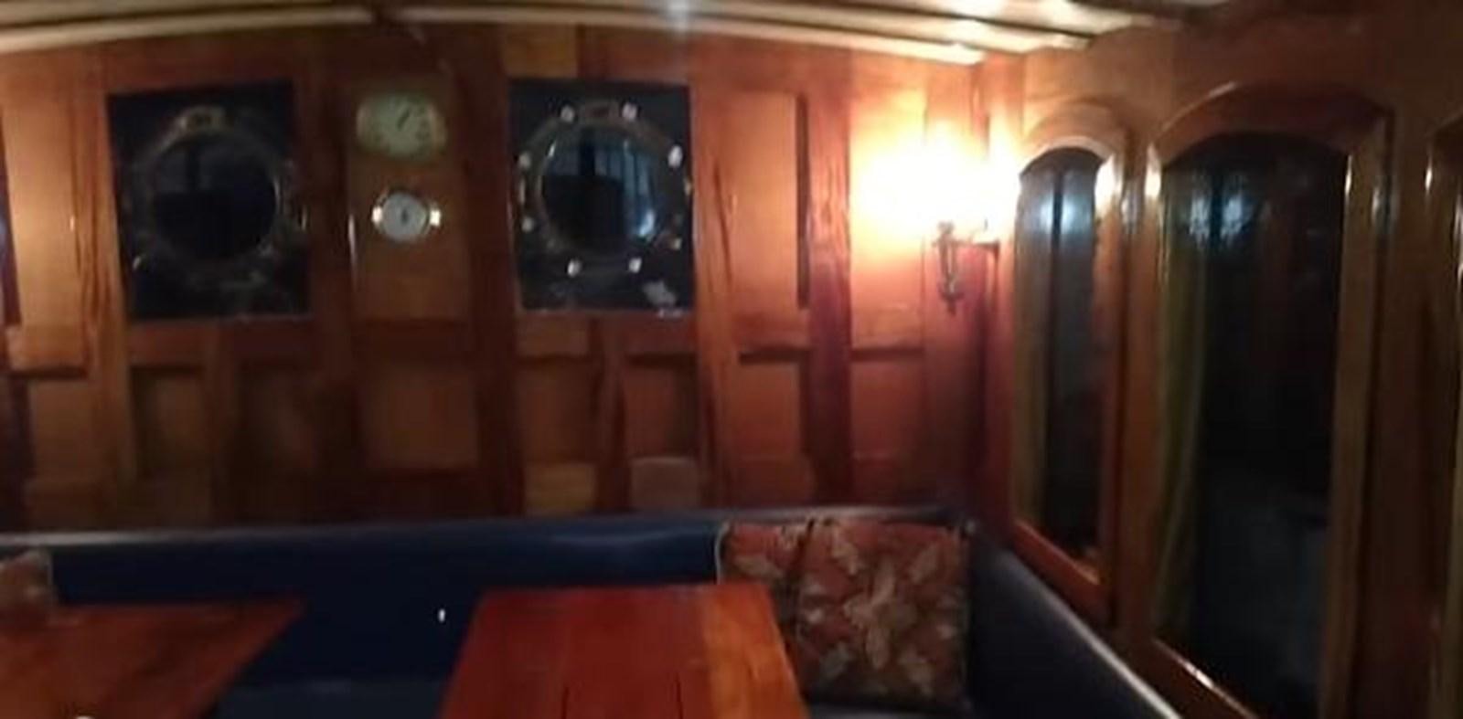 a room with a couch and a television on the wall aboard 1963 TRAWLER DE HASS NORTH SEA, WANDERBIRD  Yacht for Sale