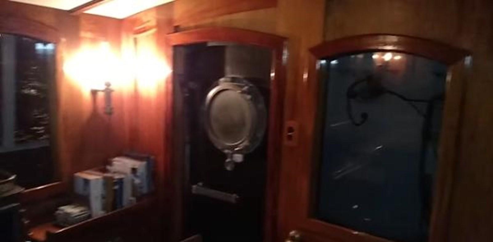 a room with a mirror and a fire extinguisher aboard 1963 TRAWLER DE HASS NORTH SEA, WANDERBIRD  Yacht for Sale