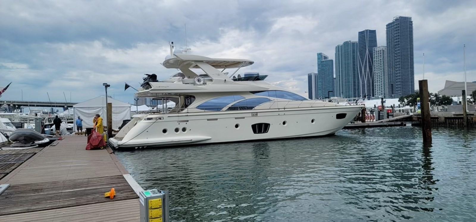 a white yacht docked at a pier aboard THINKS 'S HIS TOO Yacht for Sale
