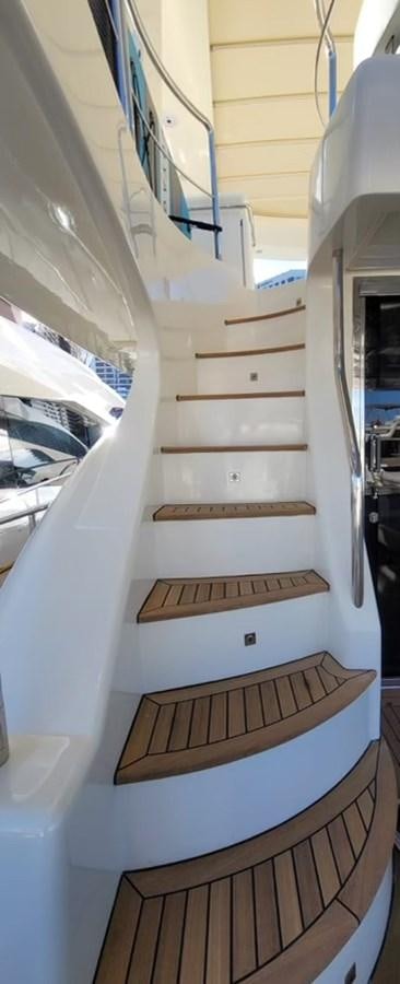 a wooden staircase with a wood railing aboard THINKS 'S HIS TOO Yacht for Sale