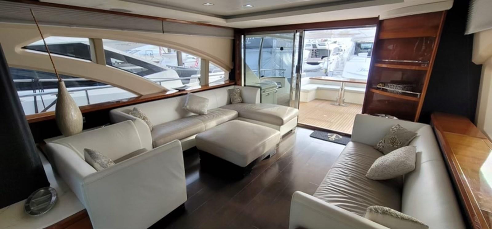 a living room with a large window aboard THINKS 'S HIS TOO Yacht for Sale