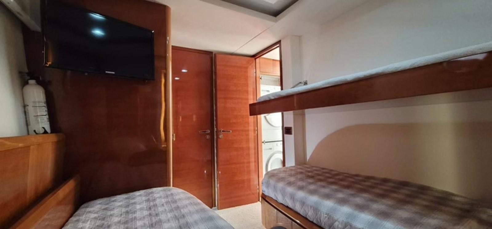 a room with a bed and a television on the wall aboard THINKS 'S HIS TOO Yacht for Sale