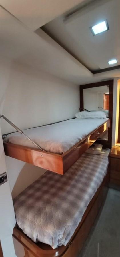 a bed with a wooden frame aboard THINKS 'S HIS TOO Yacht for Sale