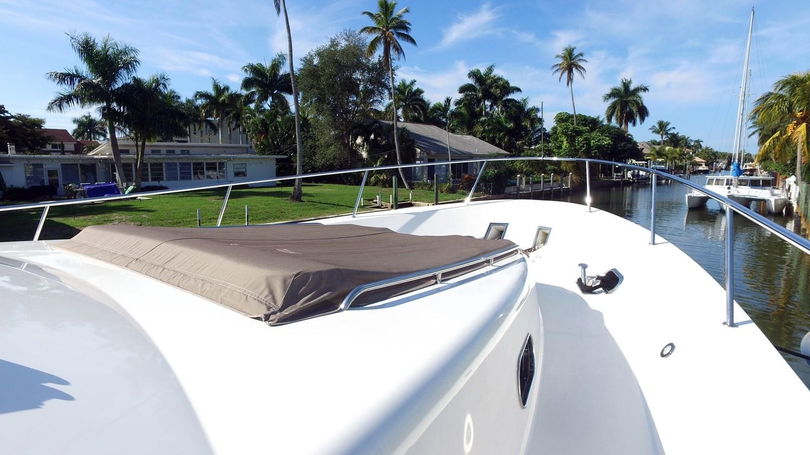 a pool with a deck and trees aboard HARBOR LADY Yacht for Sale