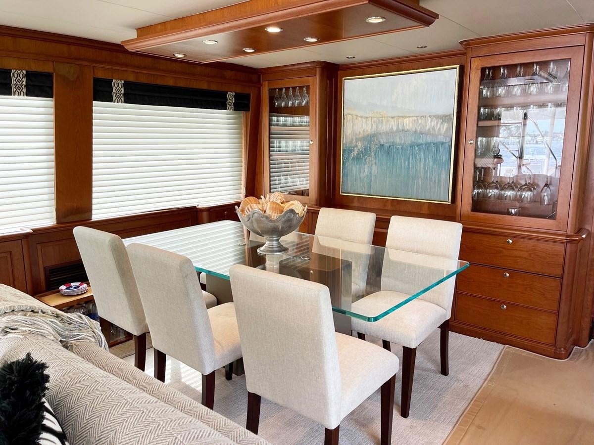 a dining room with a large window aboard HARBOR LADY Yacht for Sale