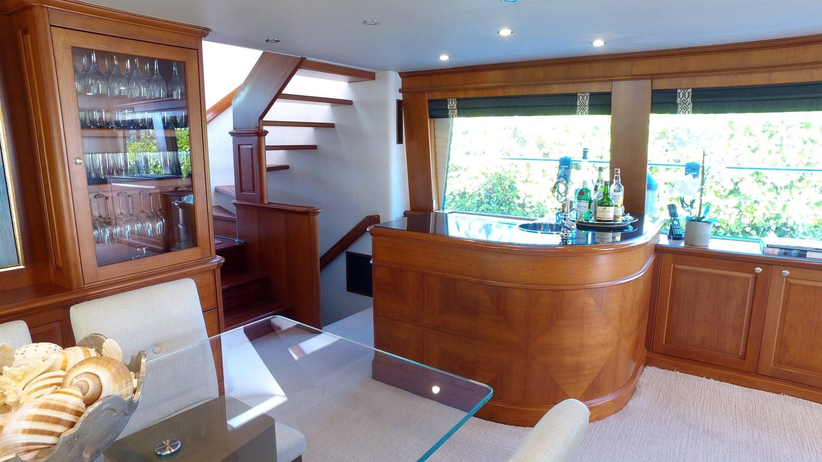 a kitchen with a bar and a table aboard HARBOR LADY Yacht for Sale