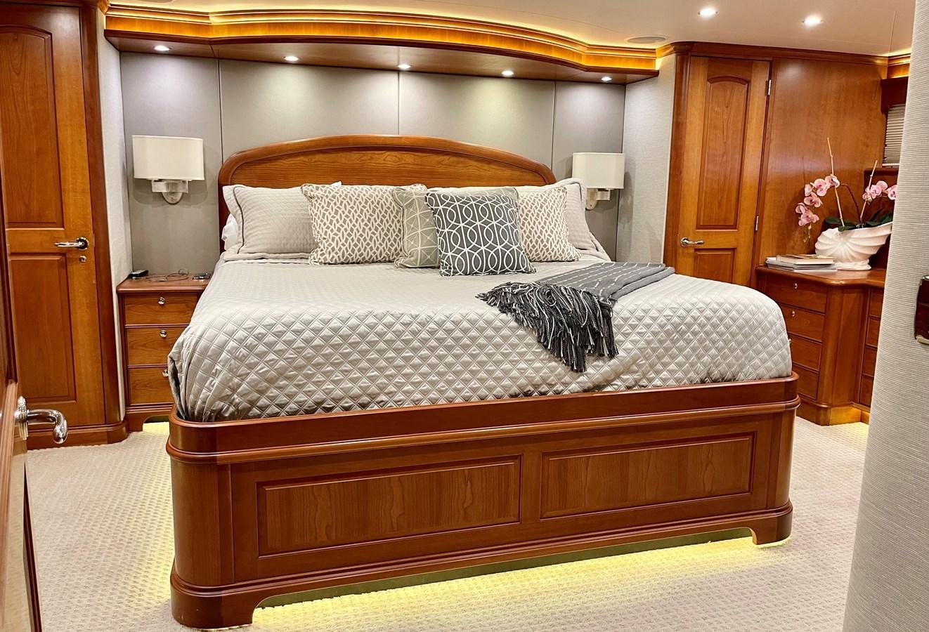 a bed with a black and white comforter and pillows aboard HARBOR LADY Yacht for Sale