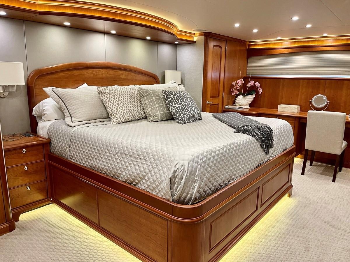 a bed with a white comforter aboard HARBOR LADY Yacht for Sale