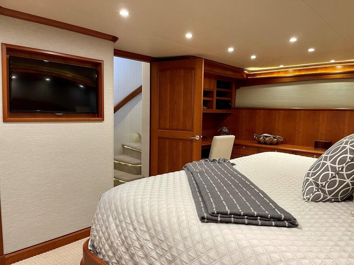 a bedroom with a bed and a television aboard HARBOR LADY Yacht for Sale