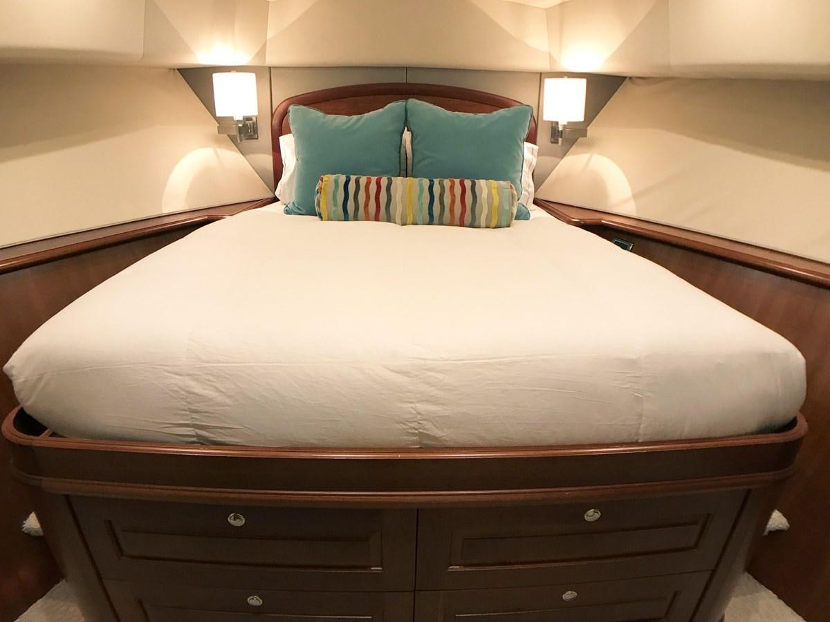 a bed with a white comforter aboard HARBOR LADY Yacht for Sale