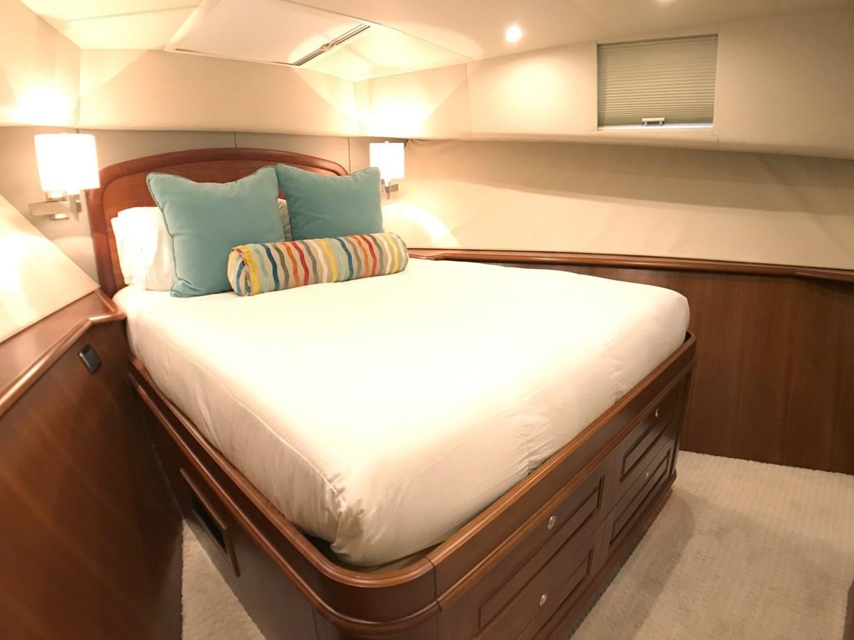 a bed with a white comforter aboard HARBOR LADY Yacht for Sale