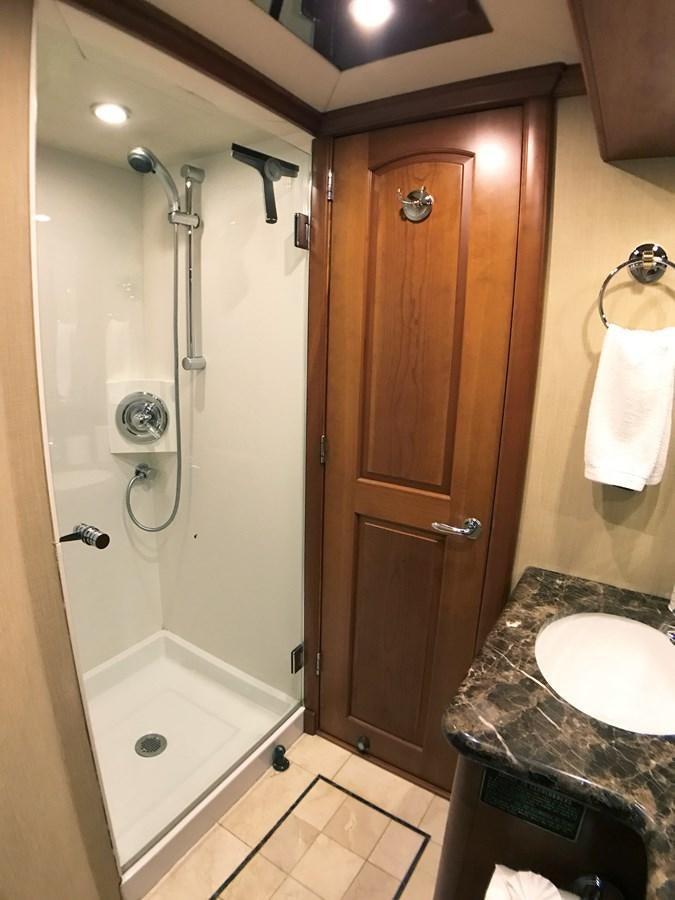 a bathroom with a shower and sink aboard HARBOR LADY Yacht for Sale