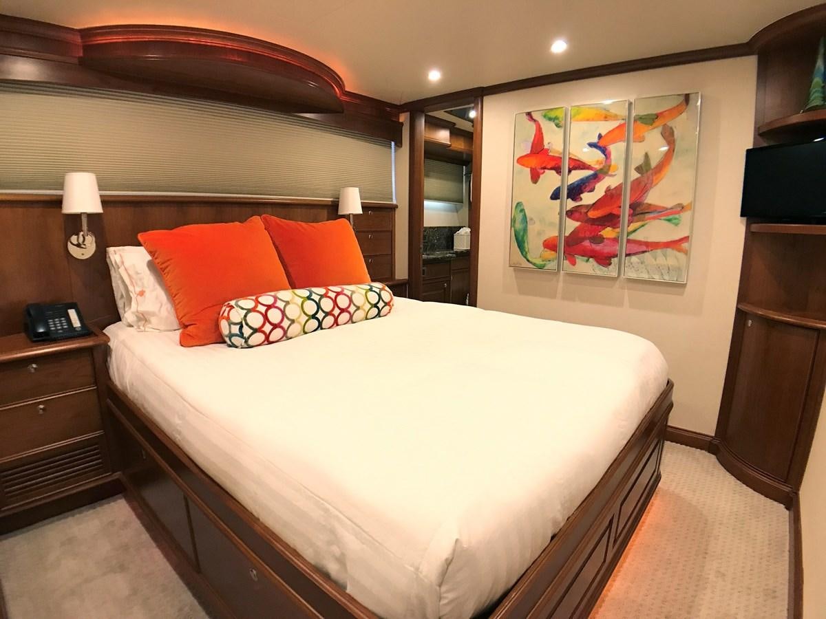 a bed with a painting on the wall aboard HARBOR LADY Yacht for Sale