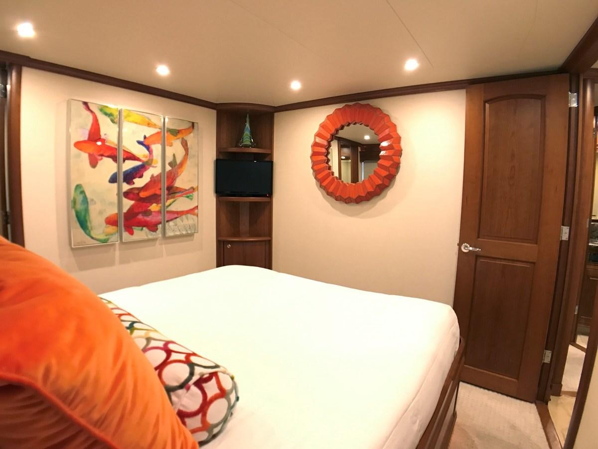 a bedroom with a bed and a mirror aboard HARBOR LADY Yacht for Sale