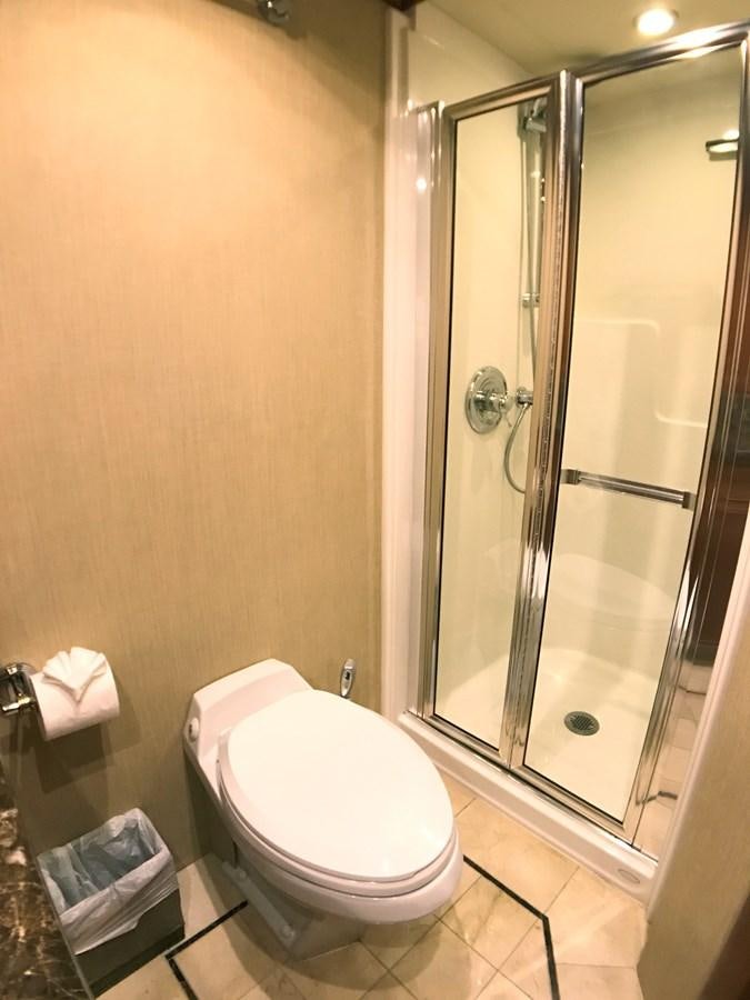 a bathroom with a glass shower aboard HARBOR LADY Yacht for Sale
