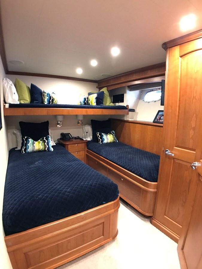 a bedroom with a bed and a desk aboard HARBOR LADY Yacht for Sale