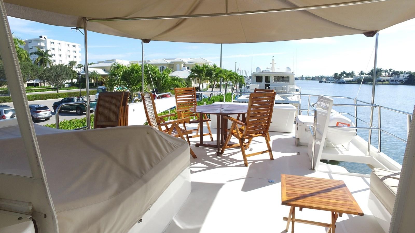 a table and chairs on a deck aboard HARBOR LADY Yacht for Sale