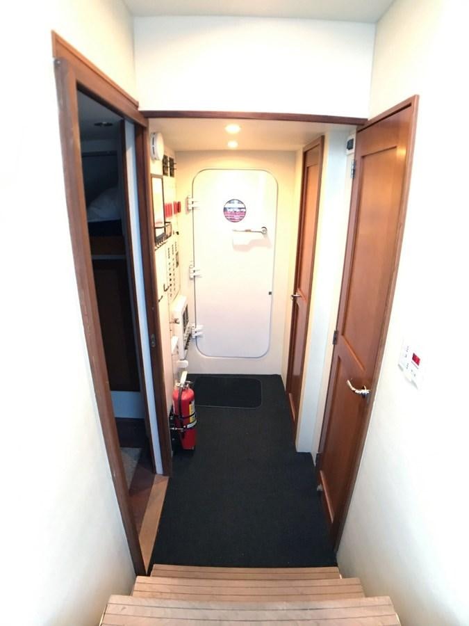 a hallway with a door and a vacuum cleaner aboard HARBOR LADY Yacht for Sale