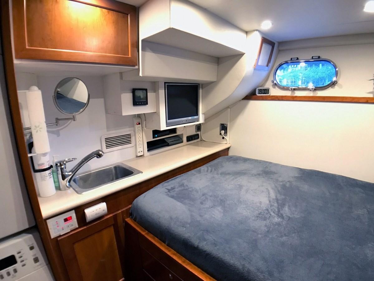 a bedroom with a bed and a sink aboard HARBOR LADY Yacht for Sale