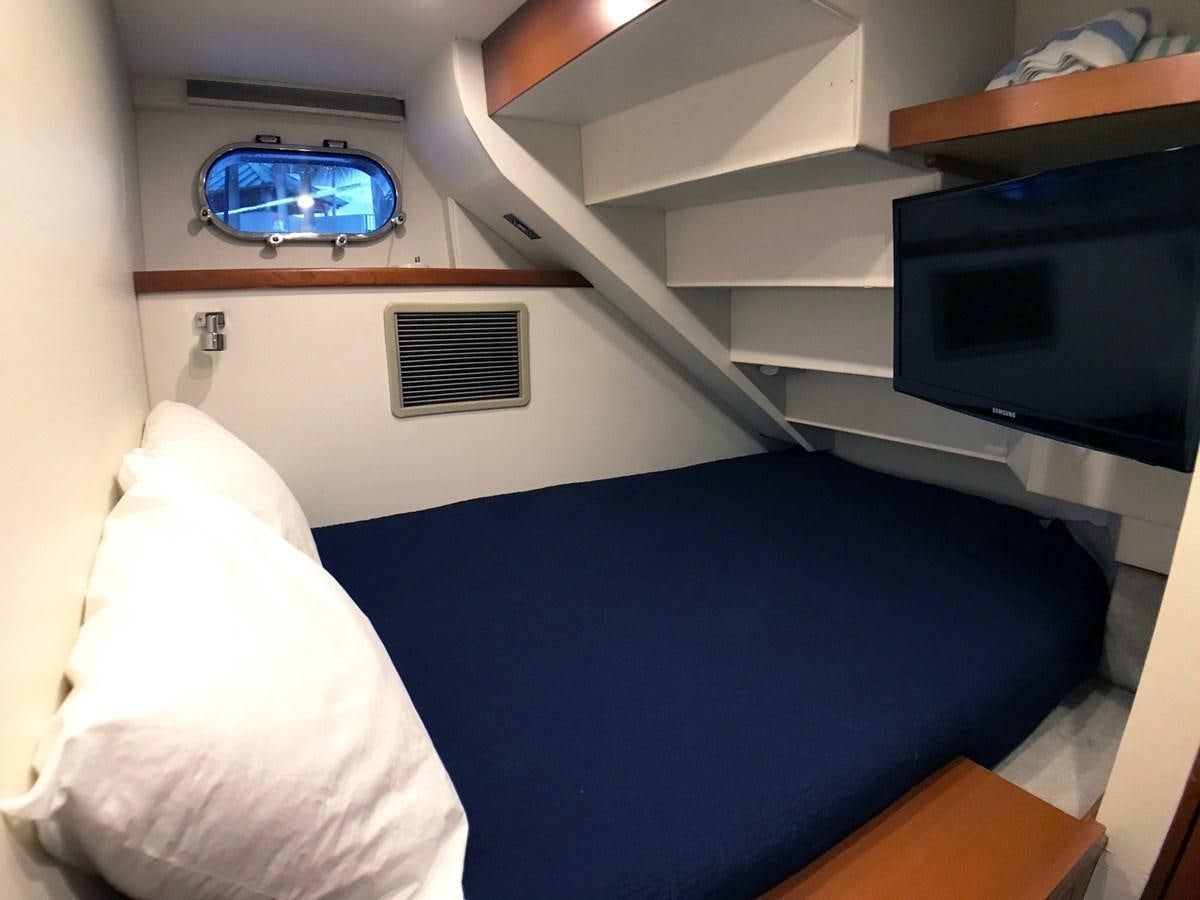 a bed with a blue bed frame aboard HARBOR LADY Yacht for Sale