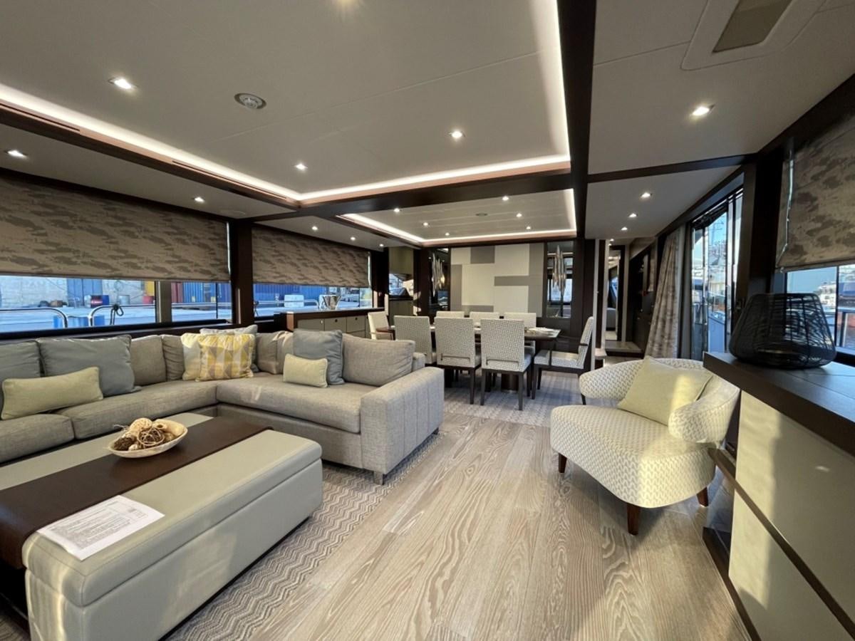 a living room with a large window aboard SUNSEEKER 95 Yacht for Sale