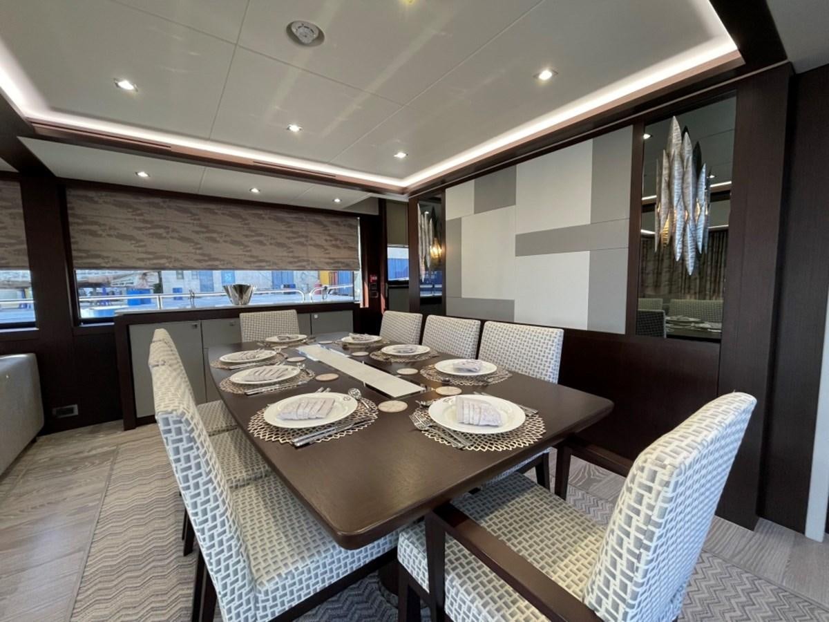 a dining table with plates and chairs aboard SUNSEEKER 95 Yacht for Sale