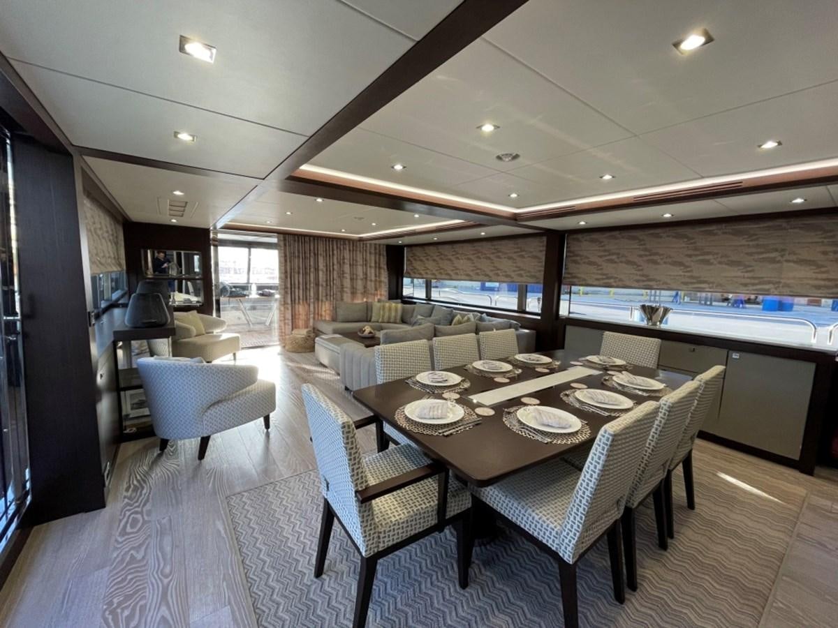 a large room with a table and chairs aboard SUNSEEKER 95 Yacht for Sale