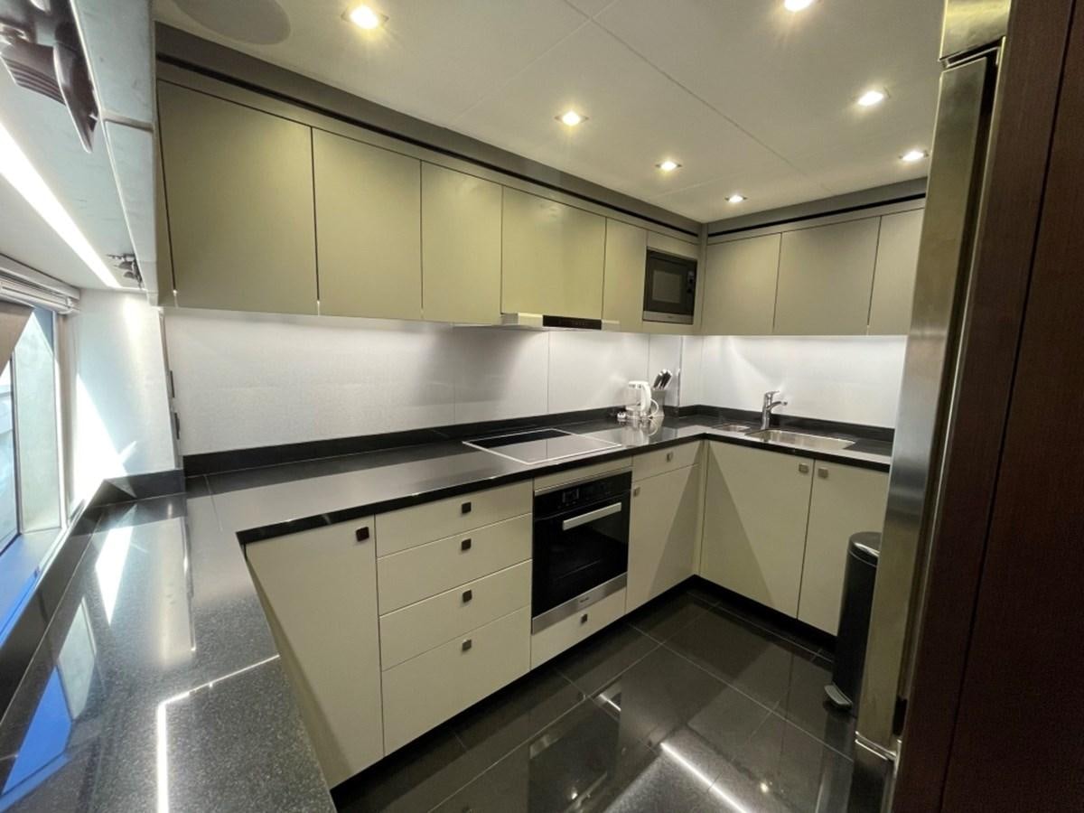 a kitchen with white cabinets aboard SUNSEEKER 95 Yacht for Sale