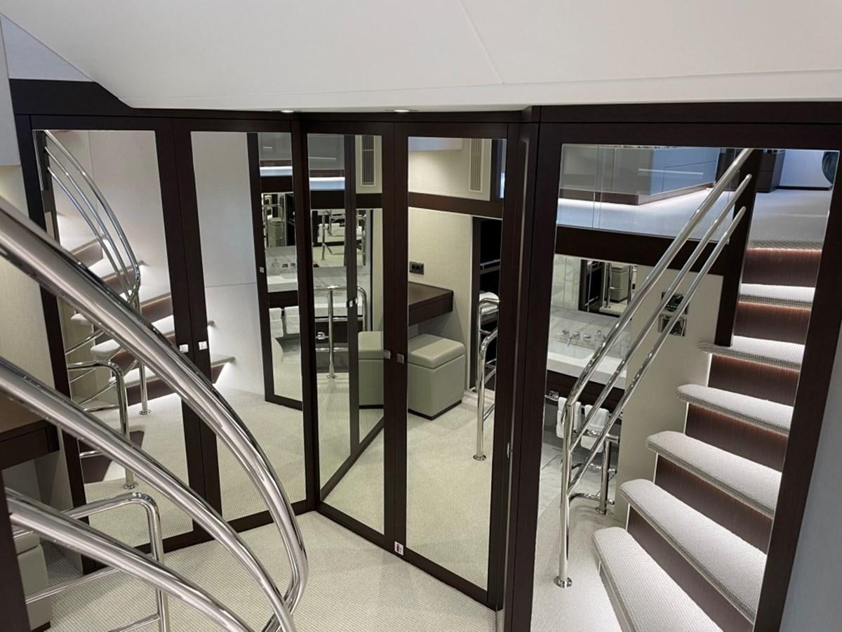 a room with a staircase and glass doors aboard SUNSEEKER 95 Yacht for Sale