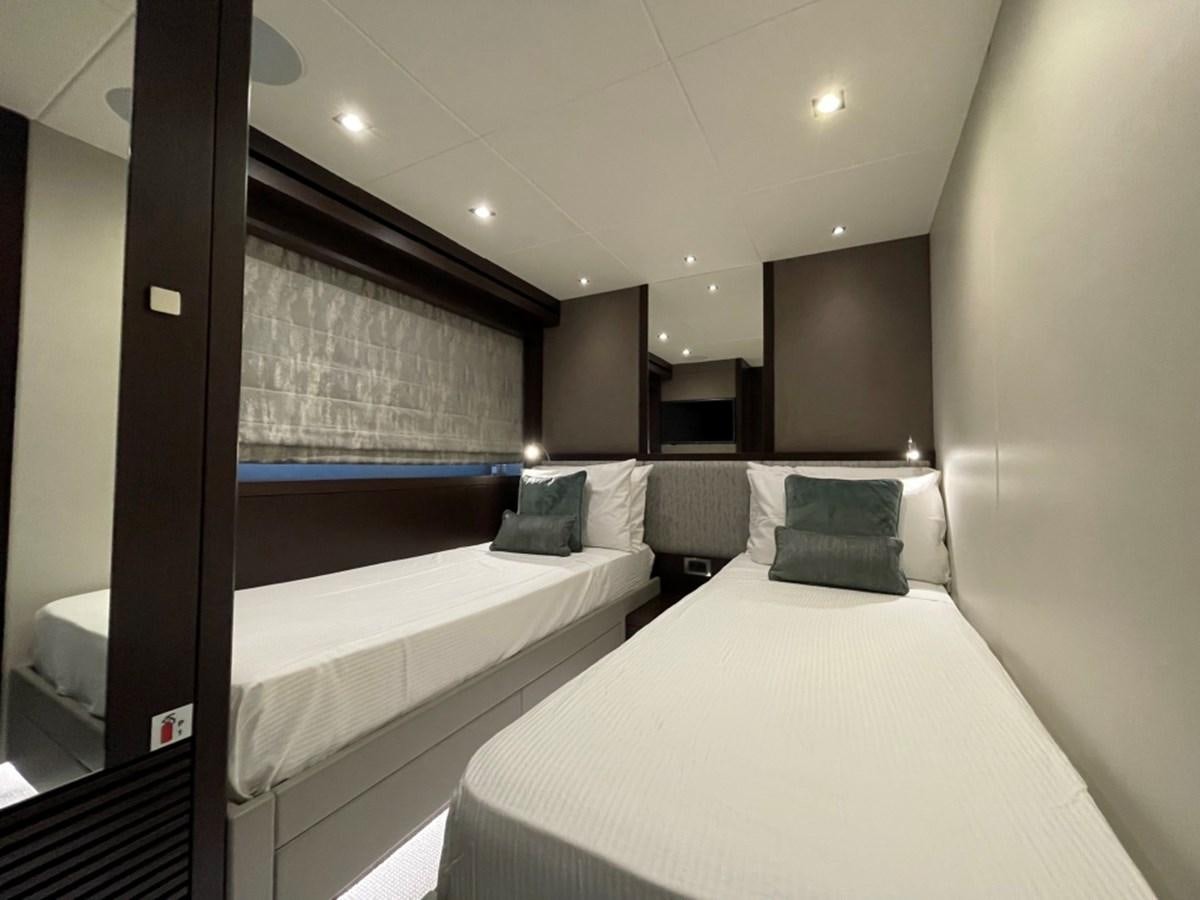 a room with a bed and a window aboard SUNSEEKER 95 Yacht for Sale