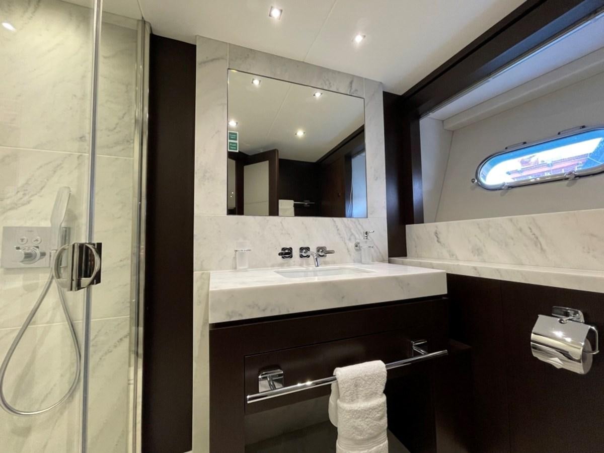 a bathroom with a sink and a mirror aboard SUNSEEKER 95 Yacht for Sale
