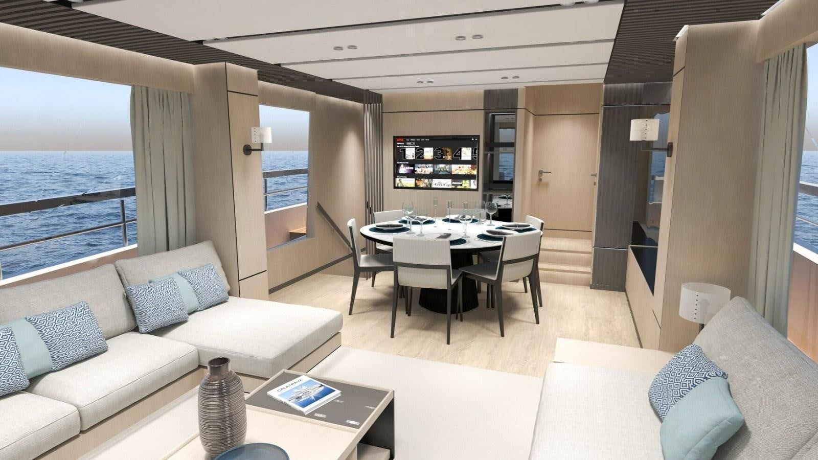 a living room with a table and couches aboard 2022 MENGI YAY  Yacht for Sale
