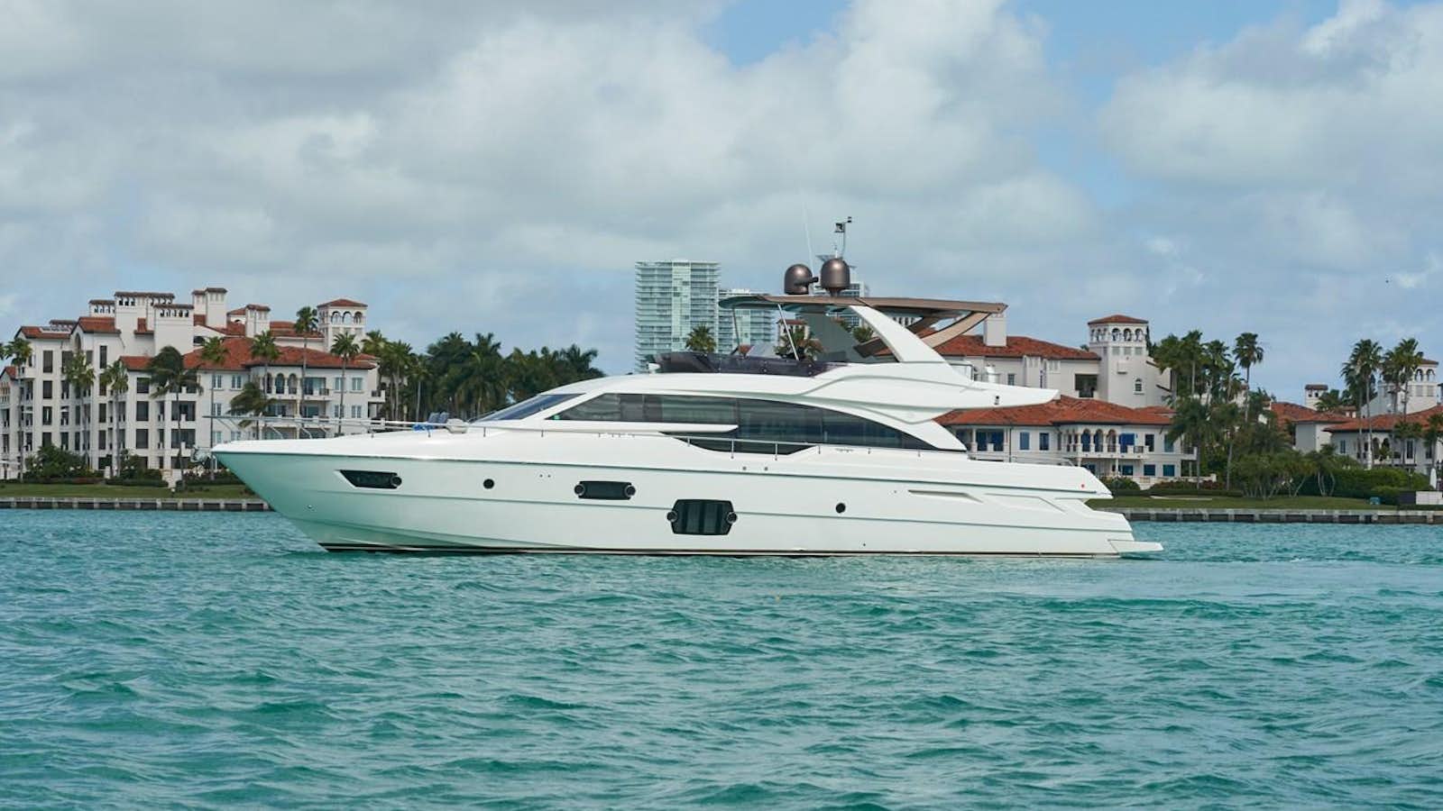 a white boat in the water aboard Mojo Yacht for Sale