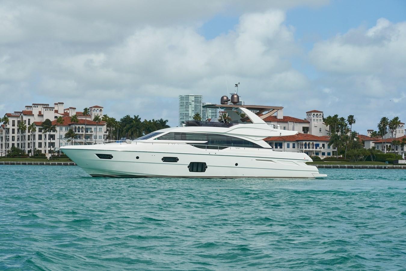 a white boat in the water aboard Mojo Yacht for Sale